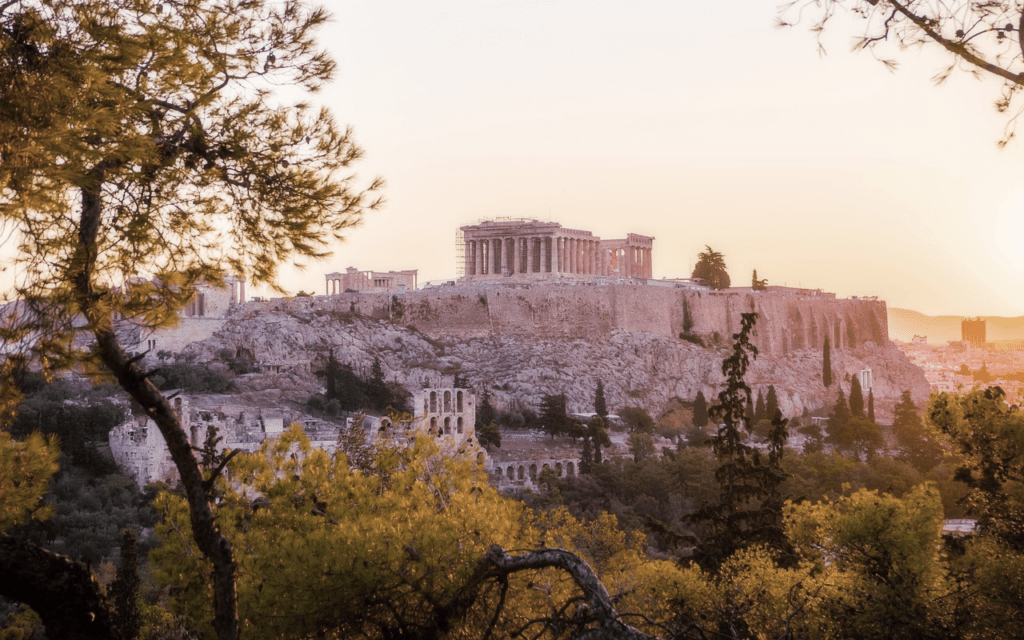 A horizon view of the Parthenon in Acropolis, Athens, Greece at sunset.